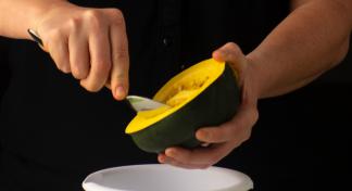 hands scooping out squash over a bowl.