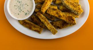 Plate with zucchini sticks and cup of low-fat ranch dressing.